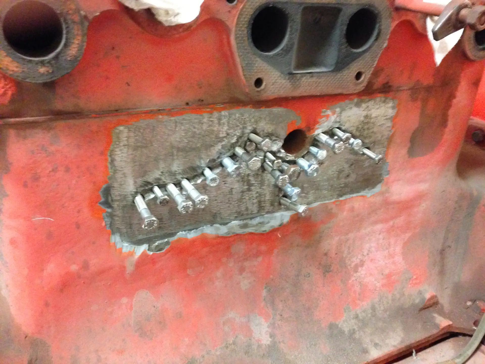 Stitching studs installed across the repair so load transfers around the damage rather than through it.