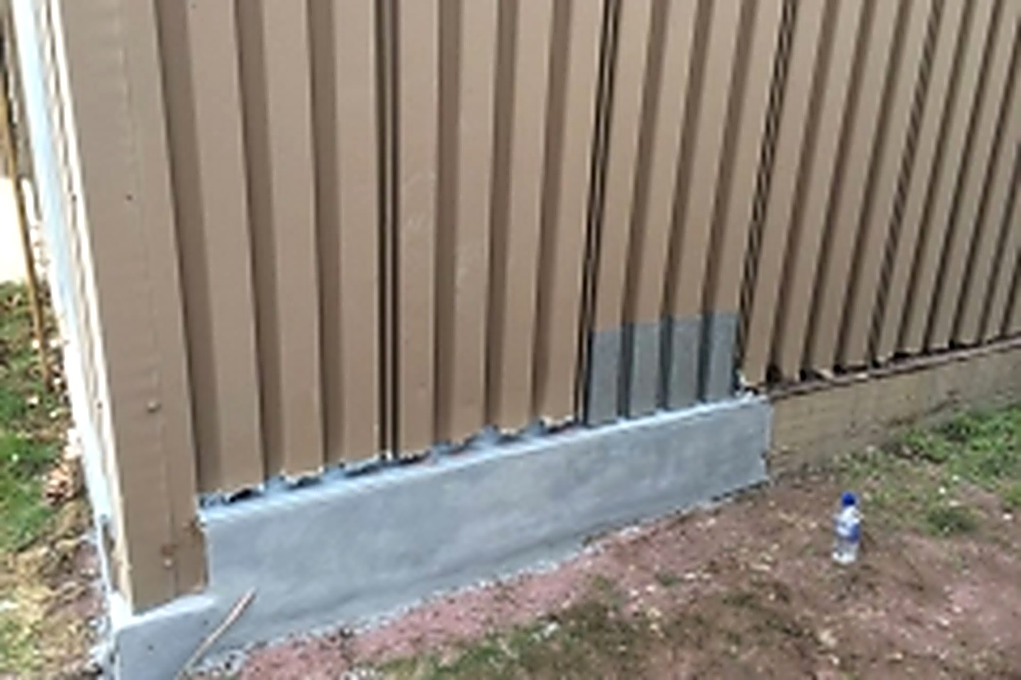 Concrete base wall rebuilt and resurfaced with Belzona, with new siding set on a sealed, weather-tight base