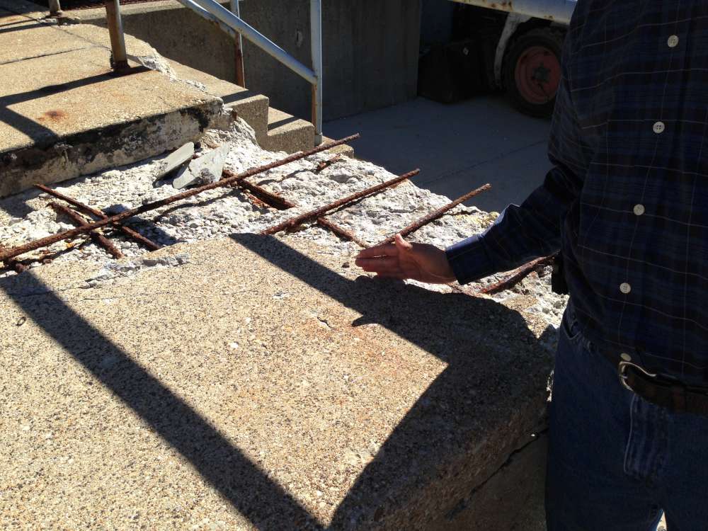 Before: spalled concrete and exposed rebar along the dock edge.