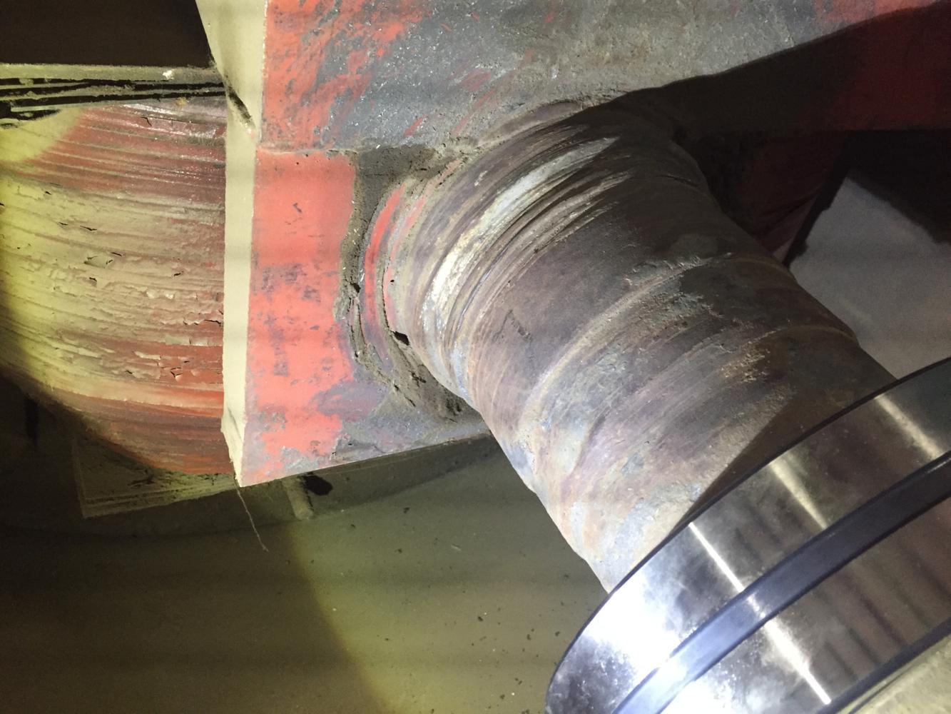 Worn metal shredder shaft at the bearing and seal area