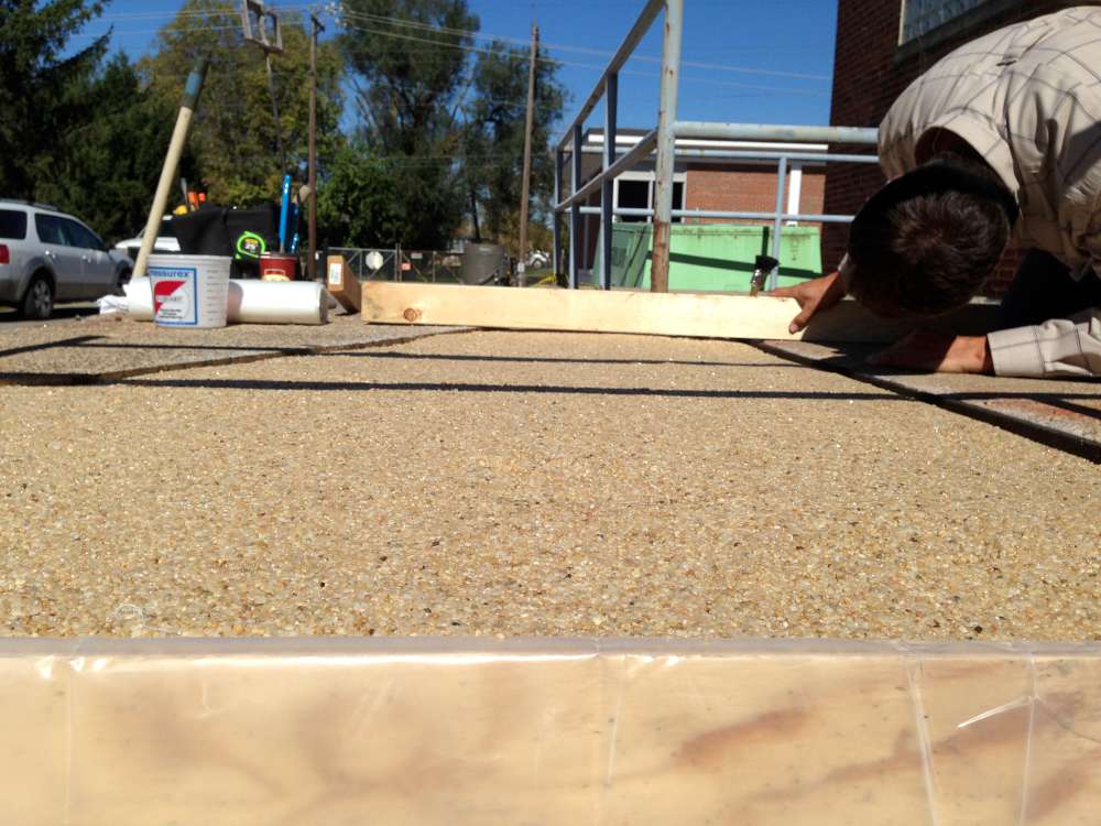 Checking the rebuilt surface with a straightedge.