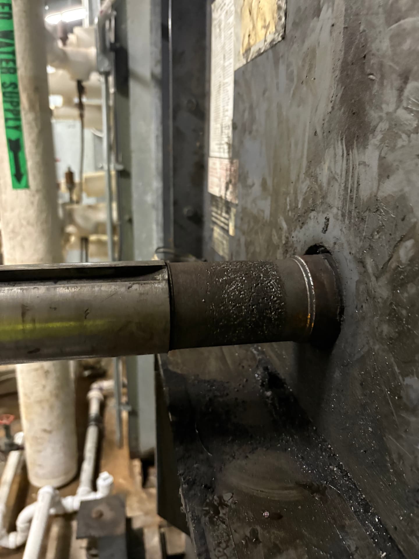 Worn pipe section at a wall penetration before Belzona repair