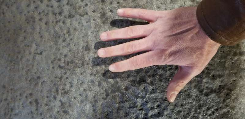 Before: close-up of the pitted surface — metal loss deep enough to feel by hand.