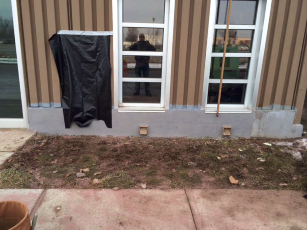 After: the window wall with its base rebuilt and resurfaced.
