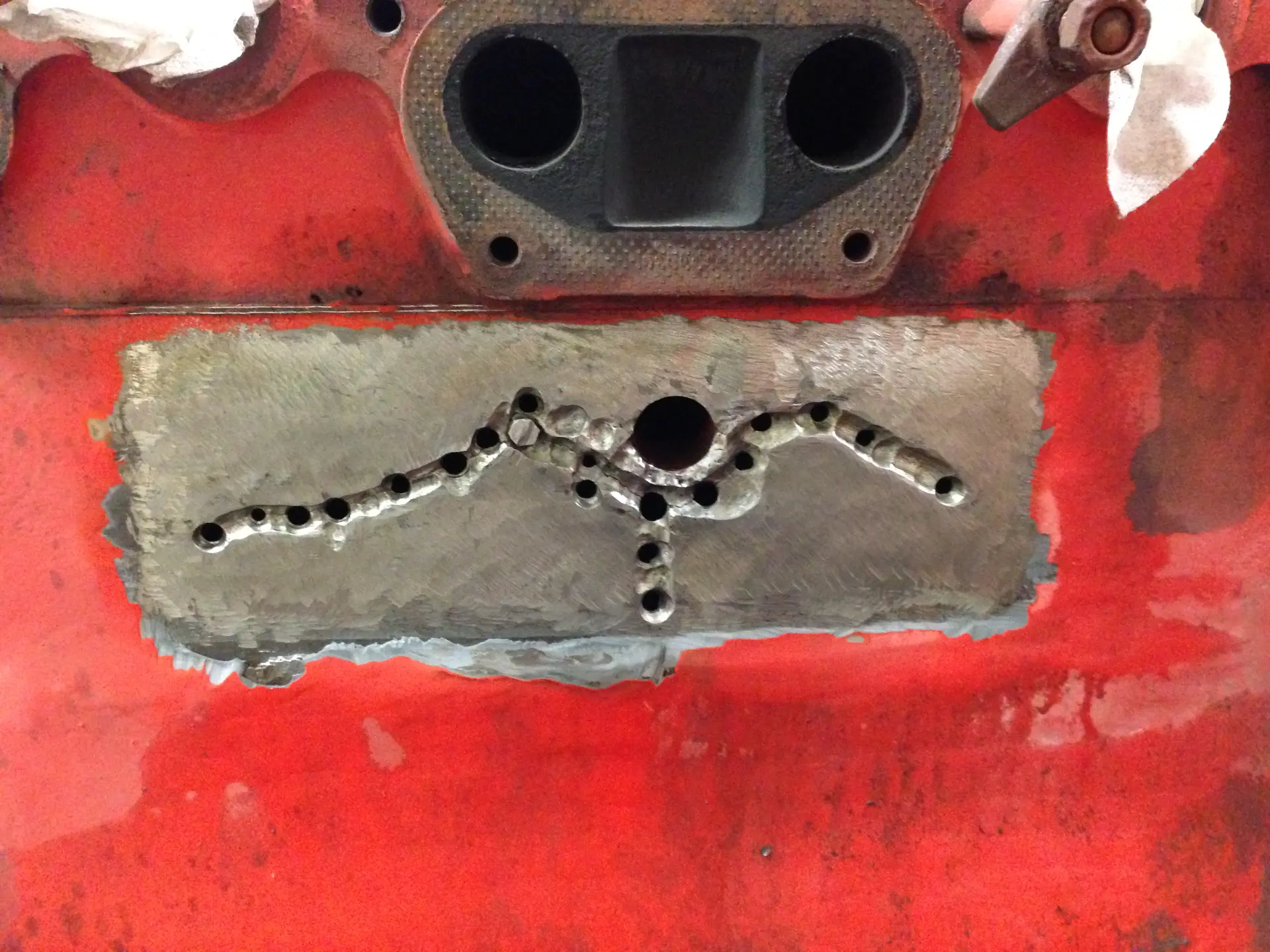Crack traced to its ends, stop-drilled, and the stitching pattern drilled and tapped along and across the crack path.