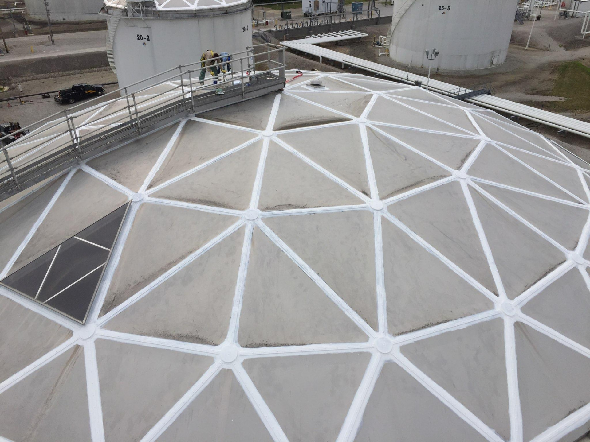 Coated geodesic tank dome at a tank farm