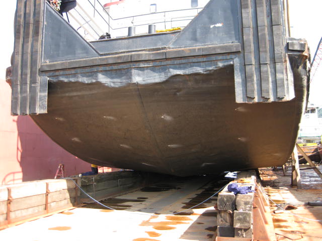 Base coat continuous across the stern and bottom of the hull.