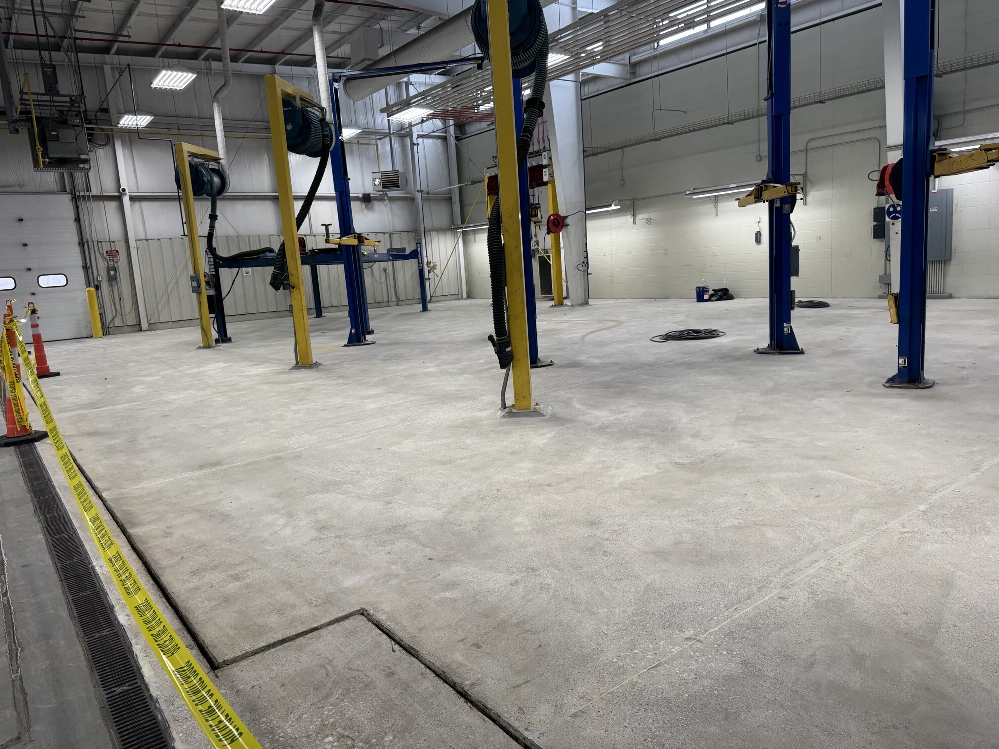 Worn, stained concrete floor in a municipal lift garage