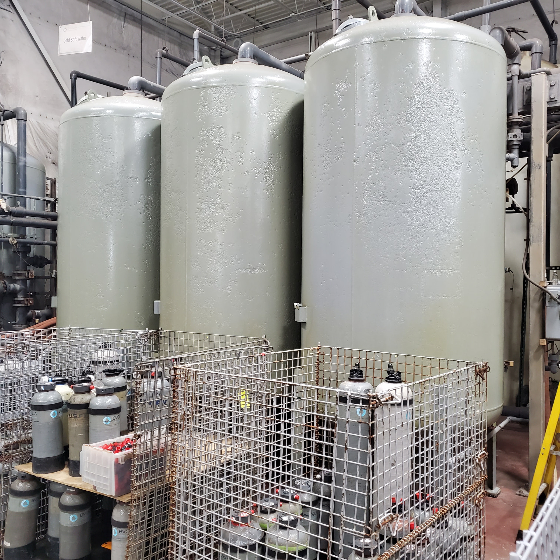 Coated water treatment vessels inside a plant