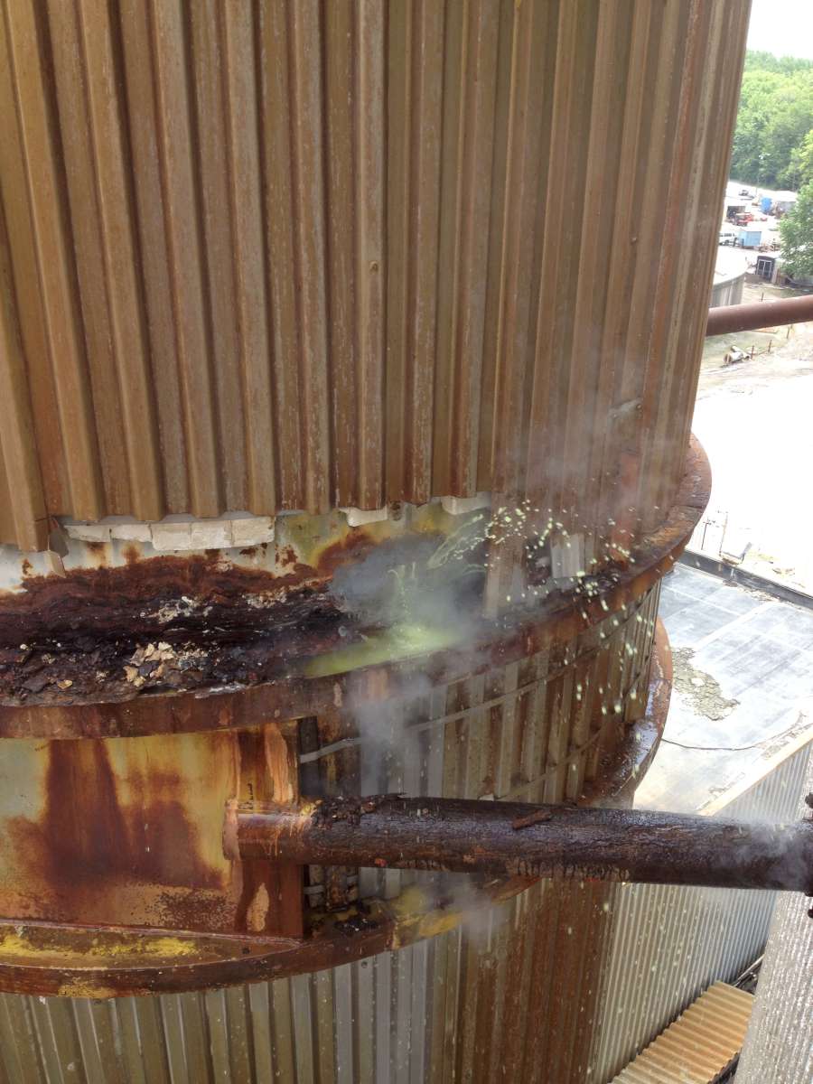 Chemical leak spraying from a corroded flow-up tube before repair