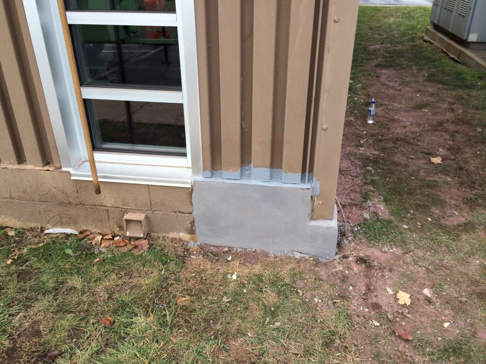 After: the corner base wall rebuilt and the siding edges sealed.