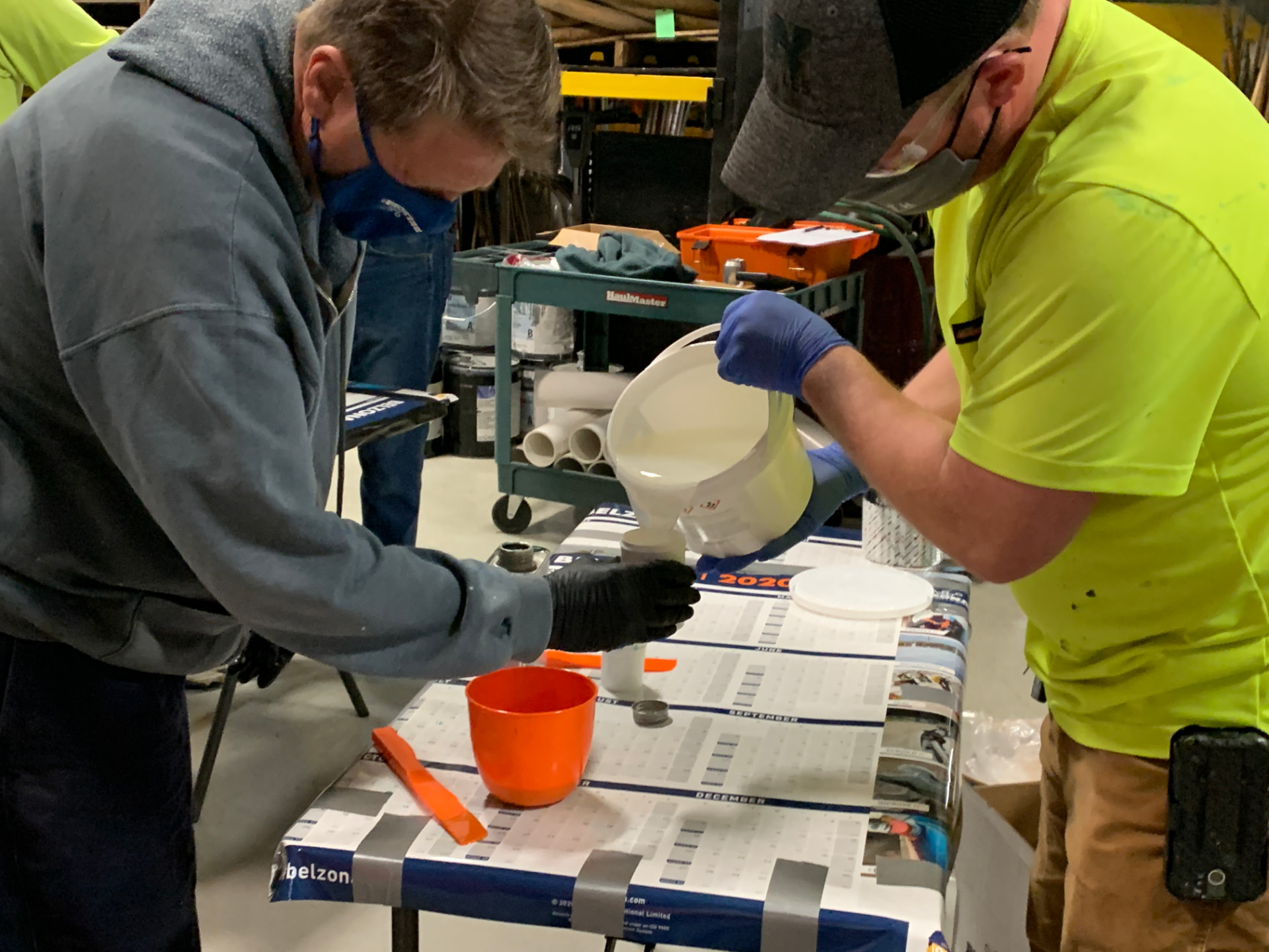 Trainees measuring Belzona material during a training session