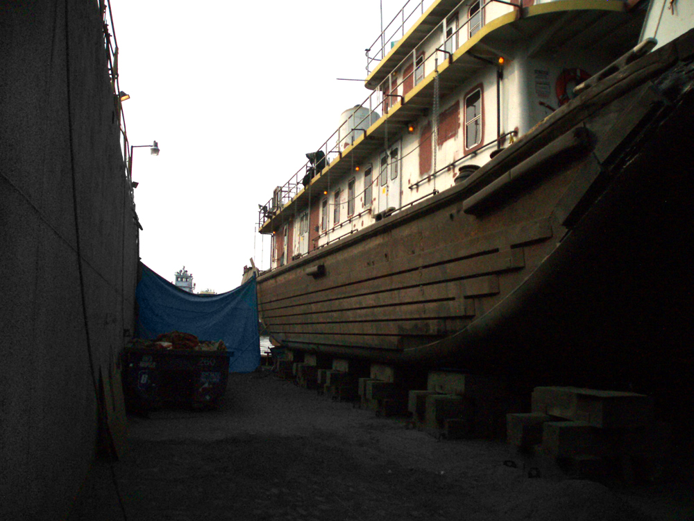 103-foot tugboat in dry dock with failed hull coating