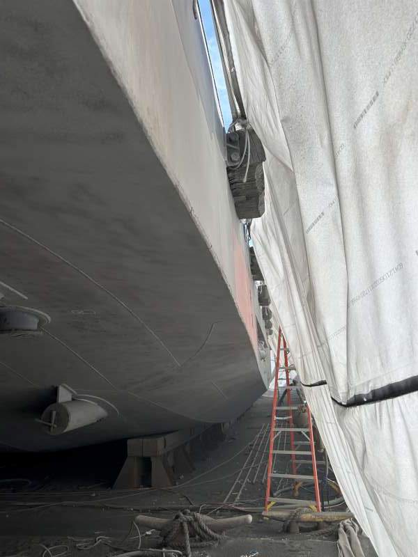 Prepared bare steel along the port side, contained under shrink wrap.