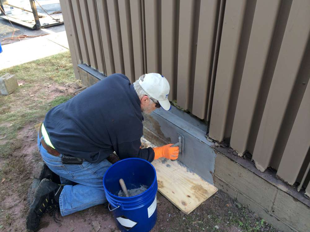 In progress: Belzona 4111 (Magma-Quartz) being trowel-applied to rebuild the concrete base wall.