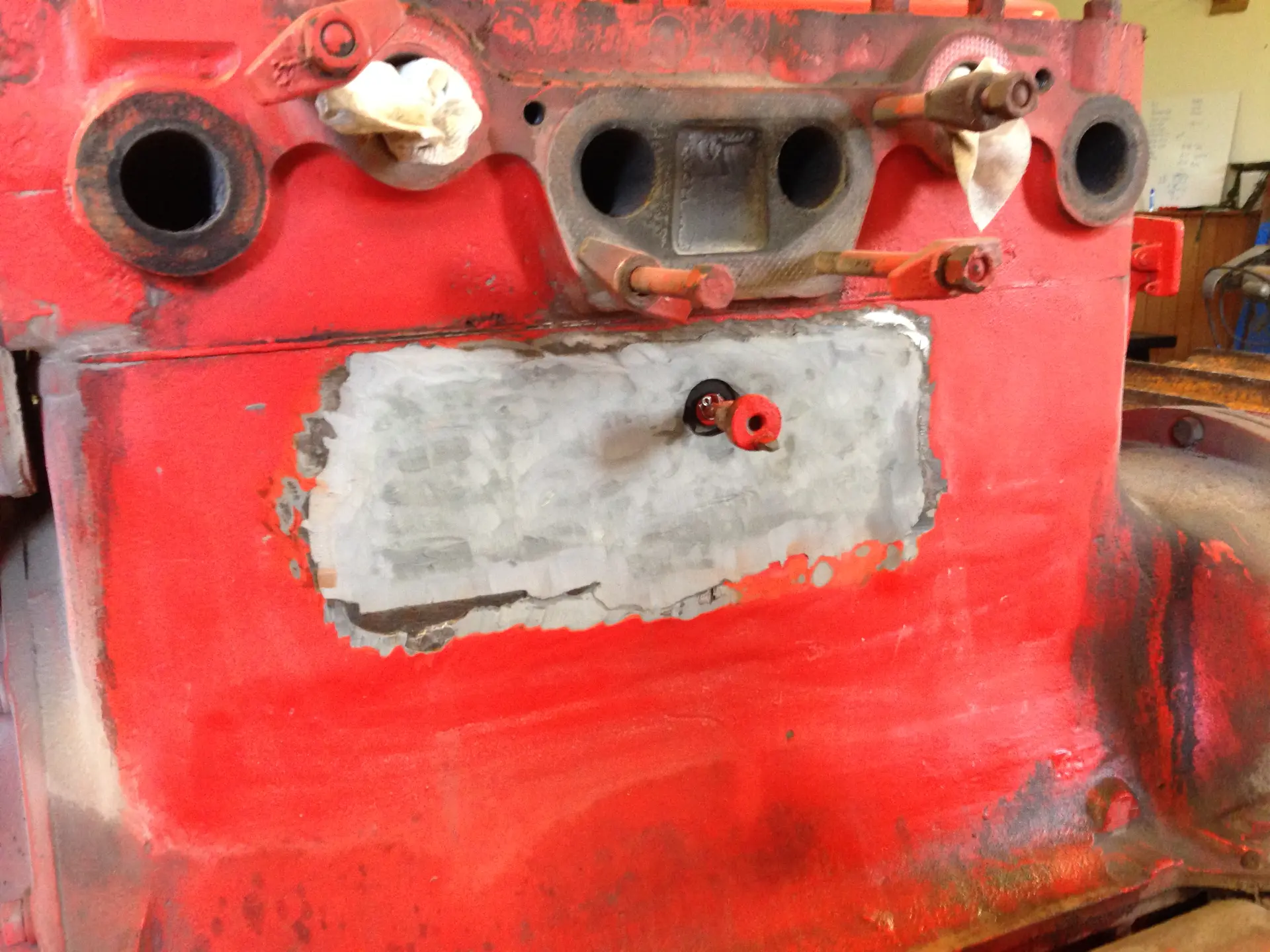 Belzona composite applied over the stitched repair and dressed back flush to the original casing contour.